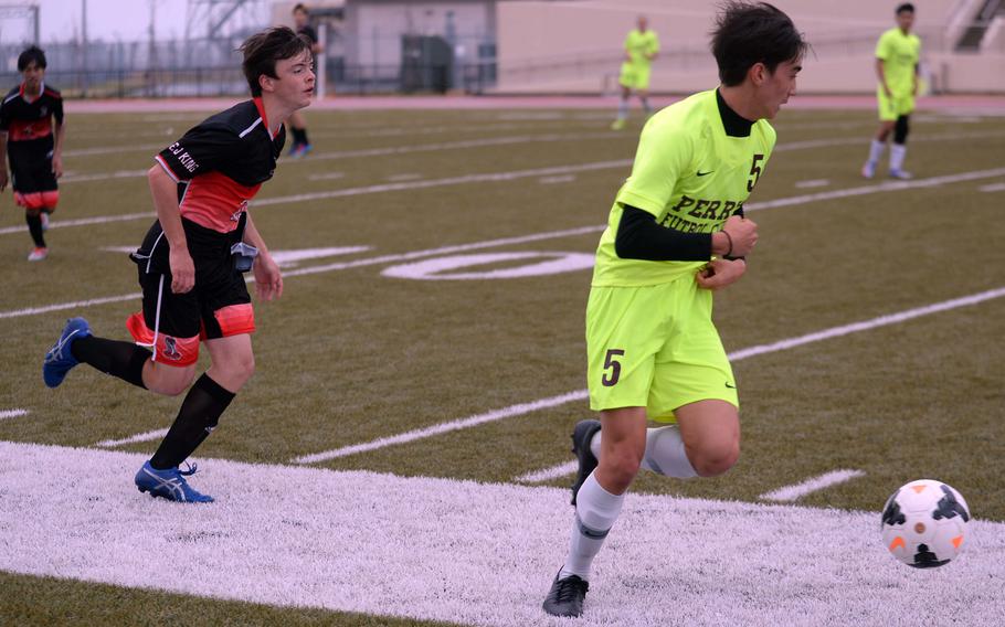 Matthew C. Perry's John Shaver dribbles up field past E.J. King's Axel Lachica during Friday's DODEA-Japan soccer match. The Samurai won 3-1.