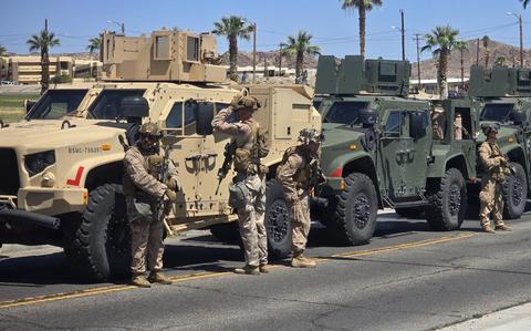 Marines with military vehicles get ready to deploy.