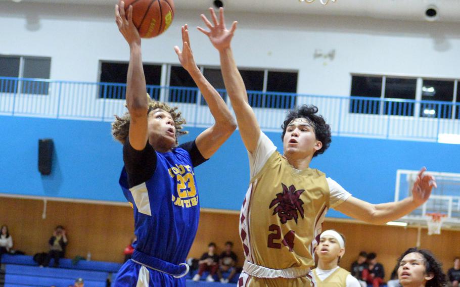 Yokota's Braedan Raybon shoots against Perry's Kameron Ramos.