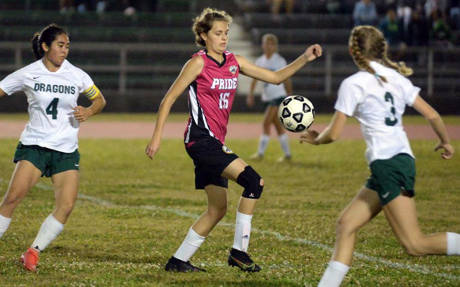 Kadena's Marina Sawyer fields the ball between Kubasaki's Michelle Swanson and Emma Leggio during Wednesday's Okinawa girls soccer match. The Panthers won 3-2.