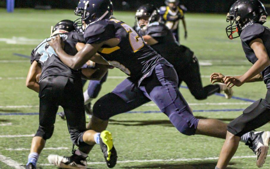 Guam High’s Charles Ellis II drags down Southern ball carrier Jaren Leon Guerrero.