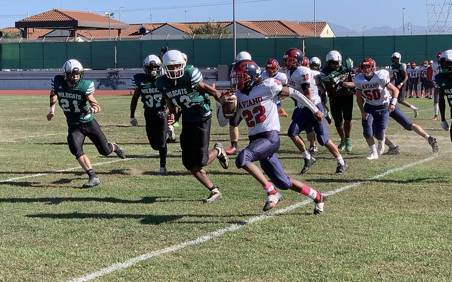 Deon Walker carries the ball for the Saints in Saturday's championship game at Naples Middle High School. Walker ultimately scored the only touchdown for the Saints.
