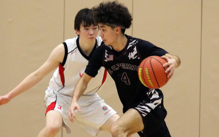 Matthew C. Perry's Tyler Gaines dribbles upcourt against St. Maur during Saturday's Western Japan Athletic Association tournament third-place game. The Samurai edged the Cougars 40-38 in extra time.