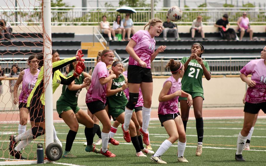 Kadena's Brooke Brewer goes high to head the ball off a Kubasaki corner kick.