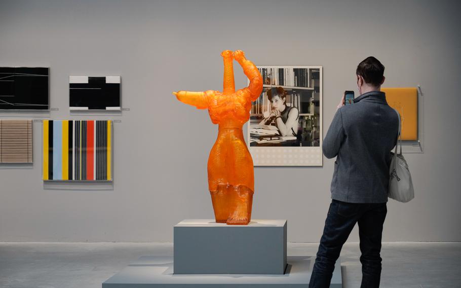 A visitor examines artwork in the central pavilion at the Biennale Art Exhibition in Venice, Italy. The exhibition grounds now host 29 pavilions with works from foreign countries.