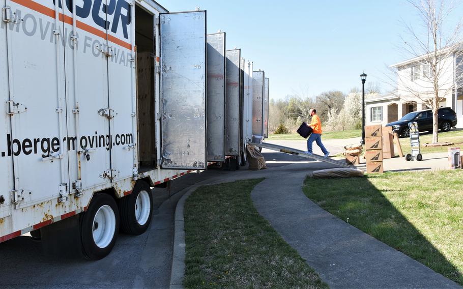 A mover carries boxes into a truck at Fort Knox, Ky., April 2, 2021.