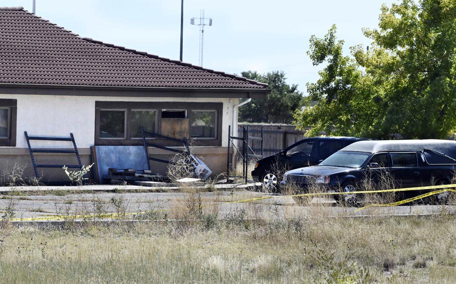 A hearse and debris can be seen at the rer of the Return to Nature Funeral Home, Oct. 5, 2023, in Penrose, Colo. The couple who owned the Colorado funeral home — where 190 decaying bodies were discovered last year — have been indicted on federal charges for fraudulently obtaining nearly $900,000 in pandemic relief funds from the U.S. government, according to court documents unsealed Monday, April 15, 2024. 