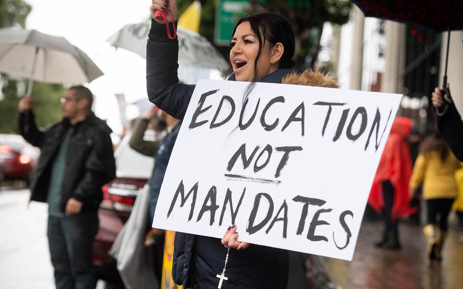 Laura Gama, a parent of an eleventh-grader, joins a rally opposing LAUSD’s student vaccine mandate outside the district office in Los Angeles while the school board meets on enforcement of the mandate on Dec. 14, 2021.