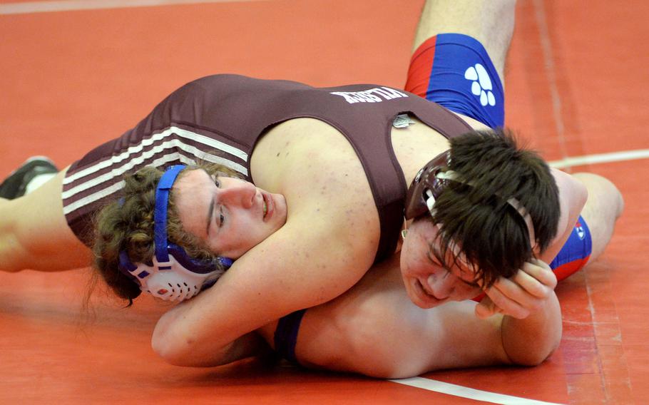 Ramstein’s Evan Brooks, left, was able to get out of the grip of Vilseck’s Isaac Lane and go on to win the 190-pound match on opening day of the high school 2022 Wrestling Tournament in Kaiserslautern.