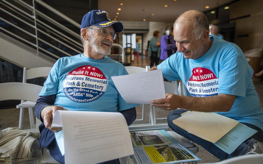 Gene Kaplin, left, and Don Geller go over notes outside an Irvine City Council meeting, where a discussion about a veterans cemetery in Irvine was on the agenda.