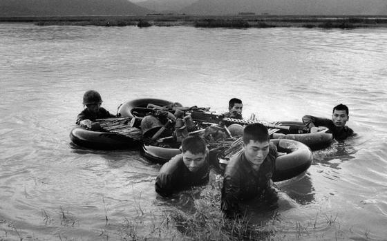 Tuy Hoa Valley, South Vietnam, Dec. 11, 1966: Troops of the 28th Republic of Korea (ROK) Regimental Combat Team use a raft of 6 inner tubes to float equipment across river in Tuy Hoa Valley. 
Looking for Stars and Stripes’ coverage of the Vietnam War? Subscribe to Stars and Stripes’ historic newspaper archive! We have digitized our 1948-1999 European and Pacific editions, as well as several of our WWII editions and made them available online through https://starsandstripes.newspaperarchive.com/
META TAGS: Pacific; South Vietnam; Vietnam war; combat; Republic of Korea army; 28th ROK Regimental Combat Team; 