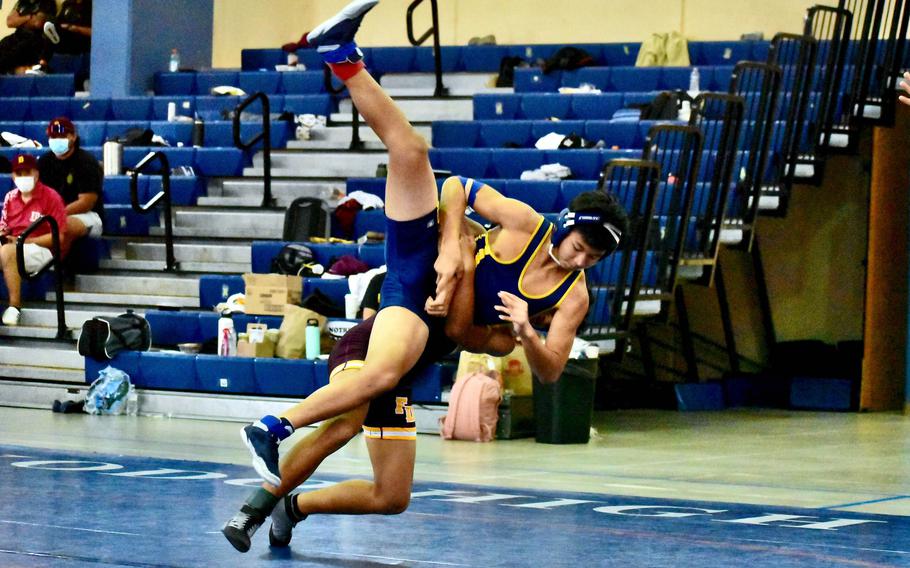 Guam High's Tavion Duenas gets lifted by Father Duenas Memorial's Christian Manglona at 138 pounds during Saturday's Guam wrestling dual meet. Duenas rallied to win by 6-3 decision, but the Friars won the meet 43-21.