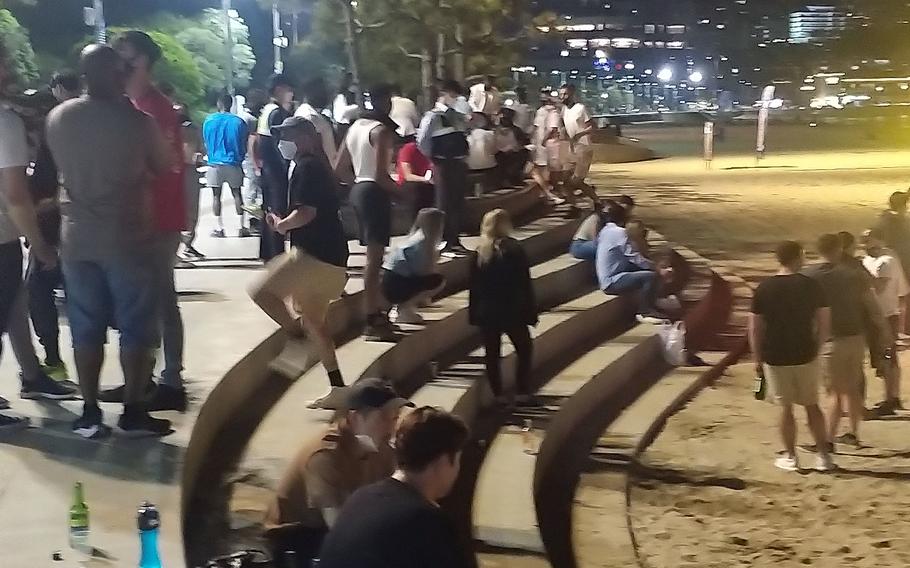 South Korean police responded to more than 30 reports of a large party involving 1,500 or more foreigners at Haeundae Beach in Busan, Saturday, May 29, 2021. Many were disregarding South Korea’s coronavirus rules for wearing masks in public areas, maintaining 6 feet between individuals and limiting groups to five people. 