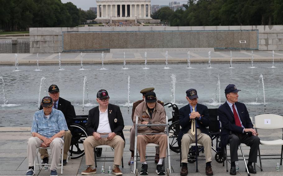 Veteran guests sit in front of the fountain at the World War II Memorial on the National Mall in Washington, D.C., on Memorial Day, April 29, 2023.