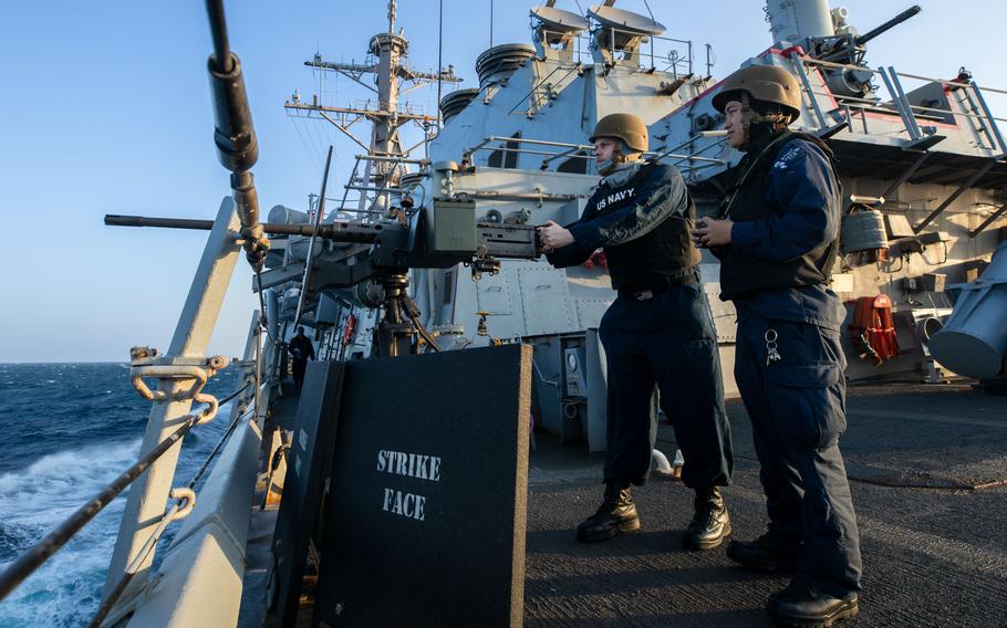 U.S. sailors man a .50 caliber machine gun as the guided-missile destroyer USS Laboon prepares to transit the Bab al-Mandeb Strait in the Red Sea Jan. 9, 2024.