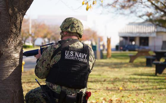 A U.S. Navy sailor prepares to engage in a mock gun battle during an active shooter drill at Yokosuka Naval Base, Japan, on Nov. 17, 2022. 