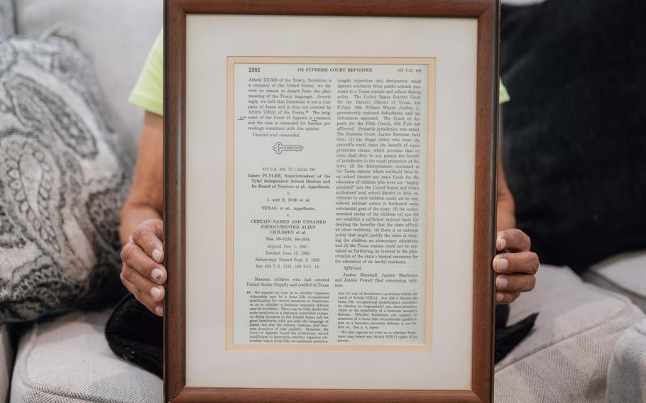 Lidia Lopez holds a framed copy of the Supreme Court decision, given to her by the Mexican American Legal Defense and Educational Fund, which represented them in court and is fighting for DACA today. 
