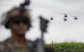 Helicopters of the 101st Airborne Division fly over Carentan, France, on June 2, 2024, as part of D-Day commemoration events. The 101st Airborne Division conducted an air assault demonstration in Normandy.