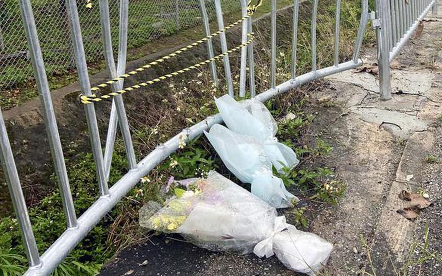 Flowers mark the site of a fatal collision outside Camp Foster, Okinawa, May 14, 2022.