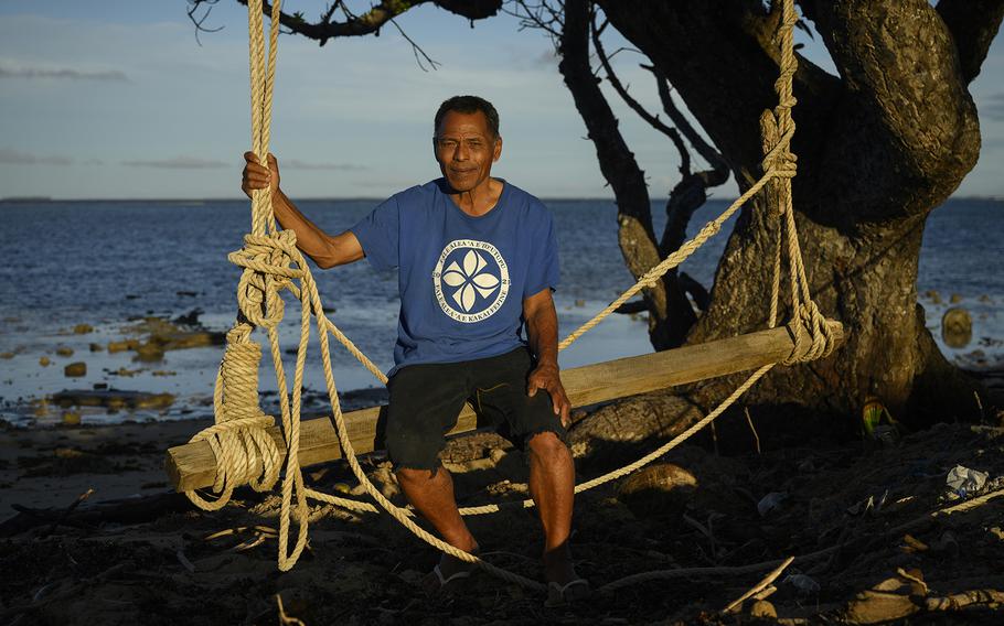 Lisala Folau sits near the mangrove tree he clung to for 27 hours to survive the tsunami.
