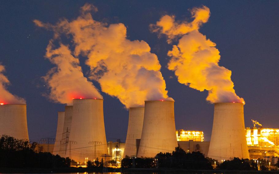 Cooling towers release vapor at the Jaenschwalde lignite coal-fired power plant, operated by EP Power Europe AS, in Peitz, Germany.