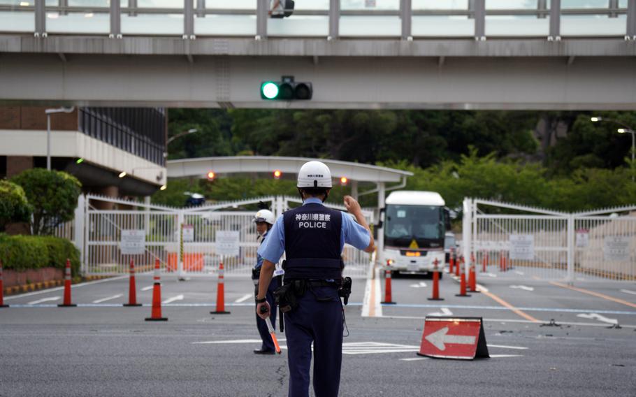 Japanese police direct traffic following a deadly collision just outside the main gate for Yokosuka Naval Base, Japan, Wednesday, Sept. 6, 2023.