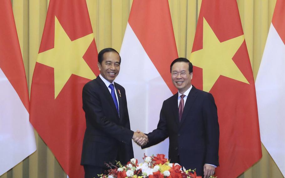 Vietnamese President Vo Van Thuong, right, and Indonesian President Joko Widodo shake hands before a meeting in Hanoi, Vietnam, Friday, Jan. 12, 2024.