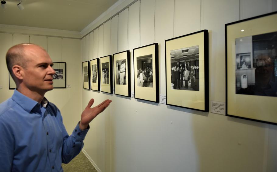 Mario Aulenbacher, the director of the Docu Center Ramstein in Ramstein-Miesenbach, Germany, talks about photographs on display depicting life on Ramstein Air Base as part of a special exhibit marking 70 years of Americans in the area.