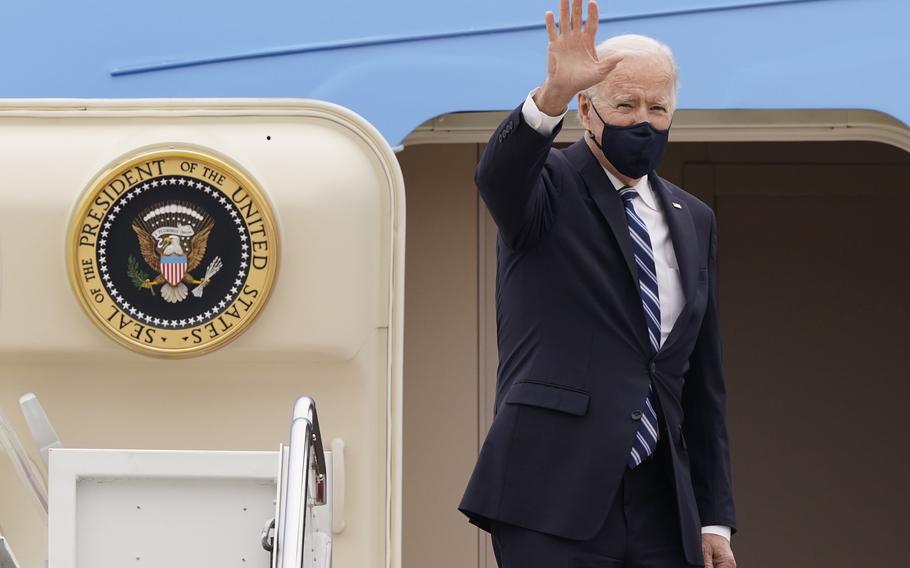 President Joe Biden waves from the top of the steps of Air Force One at Andrews Air Force Base, Md., on March 16, 2021.