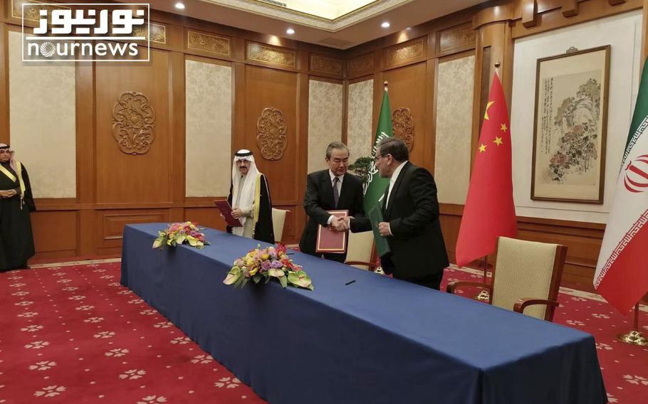 Secretary of Iran’s Supreme National Security Council, Ali Shamkhani, right, shakes hands with China’s most senior diplomat Wang Yi, as Saudi Arabia’s National Security Adviser Musaad bin Mohammed al-Aiban looks on during an agreement signing ceremony between Iran and Saudi Arabia, in Beijing, China, March 10, 2023.