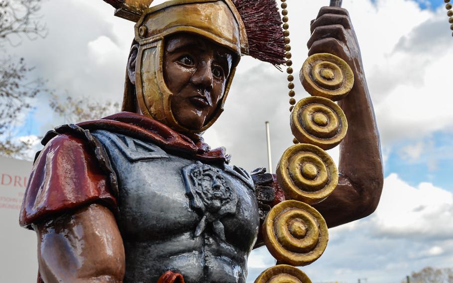 A legionnaire statue welcomes visitors to the Roman theater in Mainz, Germany. A small information trailer gives visitors site information about the ancient Roman settlement that eventually developed into modern-day Mainz.