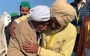 A video screen grab shows Sikka Khan, right, hugging his older brother Sadiq. The two were separated during India’s war of partition in 1947 and reunited after 74 years. 