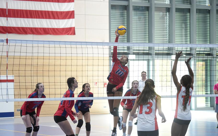Aviano’s Sophia Fisher knocks down a spike in the opening set of the DODEA-Europe girls' Division II championship match on Saturday Oct. 29, 2022, at Ramstein High School.