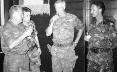 FILE - Bosnian Serb army Commander General Ratko Mladic, left, drinks with Dutch U.N Commander Tom Karremans, second right, while others unidentified look on, in Potocari, some 5 kilometers (3 miles) north of Srebrenica,  Bosnia, July 12, 1995. The Dutch government formally apologized Saturday, June 18, 2022 to soldiers who were sent as United Nations peacekeepers to defend the Bosnian enclave of Srebrenica with insufficient firepower and manpower to keep the peace. (AP Photo, File)