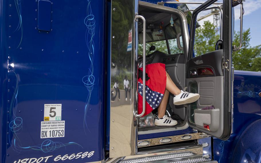 A woman in a patriotic dress rests