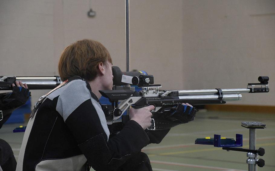 Wiesbaden's Matthew Hise looks through his spotting scope after taking a shot during the kneeling portion of a marksmanship meet Saturday, Dec. 10, 2022, at RAF Alconbury, England. Shooters are able to use their spotting scopes to self-assess their shots during competition. 