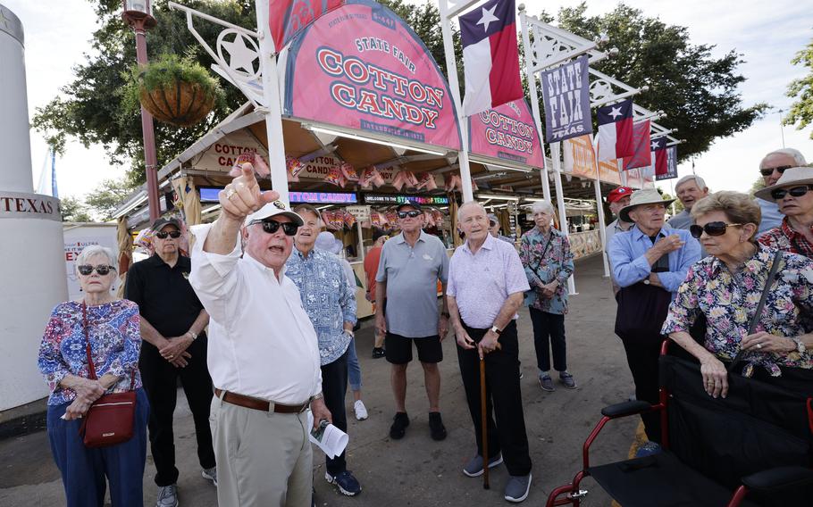 Errol McKoy, former State Fair of Texas president, talks to a group Vietnam veterans and their wives during a tour of the fair.