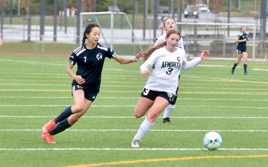 AFNORTH defensive midfielder Sara Nix and Black Forest Academy attacker Haewon Park chase after a ball during a match on April 20, 2024, at Ramstein High School on Ramstein Air Base, Germany.
