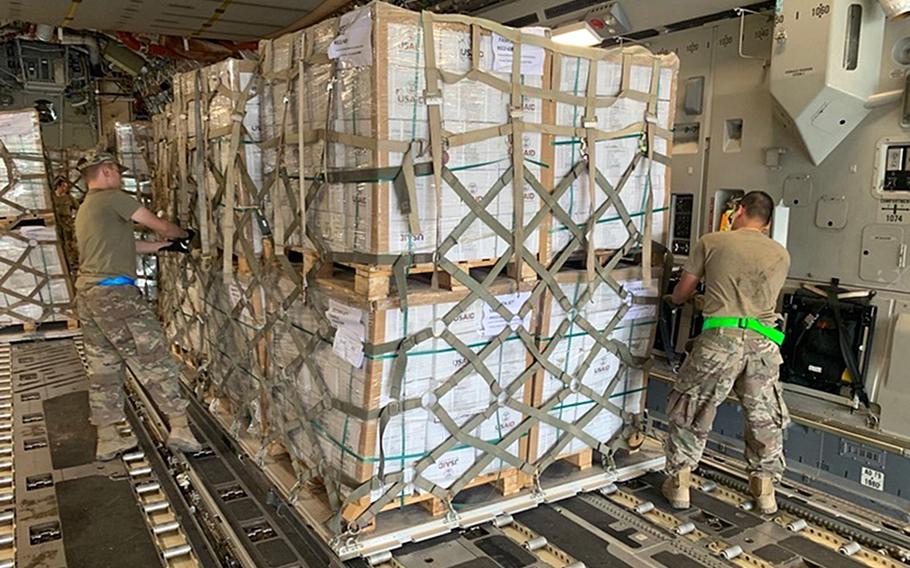 Airmen from the 387th Air Expeditionary Squadron quick reaction team prepare to offload humanitarian supplies from a C-130 airplane at Begum Nusrat Bhutto Airport Sukkur, Pakistan, Sep. 9, 2022. 