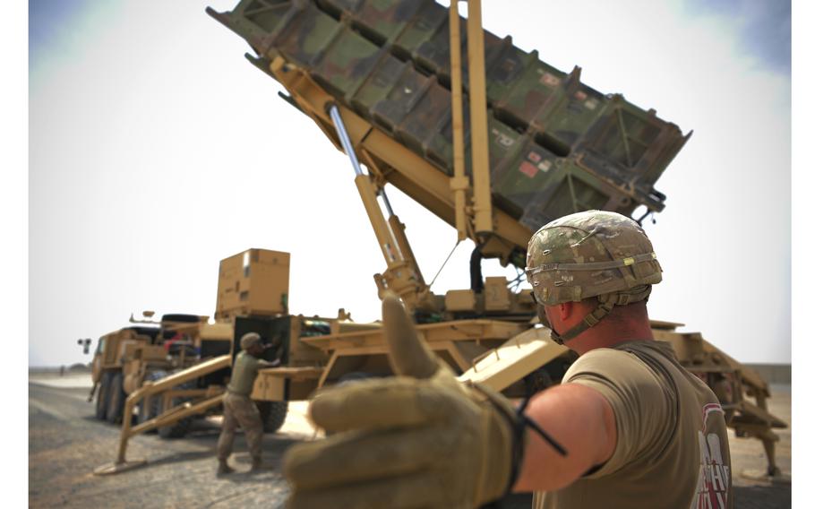 U.S. Army Spc. Scottlin Bartlett of the 5-52 Air Defense Artillery Battalion signals to a colleague while working near a Patriot missile battery at Al-Dhafra Air Base in Abu Dhabi, United Arab Emirates, May 5, 2021. The head of U.S. Central Command, U.S. Marine Corps Gen. Kenneth McKenzie Jr., arrived in the United Arab Emirates on Sunday to build on recent measures announced by the Pentagon to help reinforce the UAE’s defenses after attacks by Iranian-affiliated rebels in Yemen.