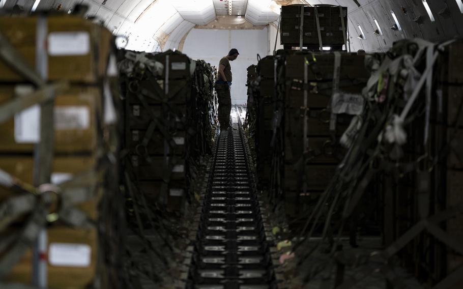 Senior Airman Nicholas Surdukowski, 436th Aerial Port Squadron ramp services specialist, assists in loading ammunition onto a commercial plane bound for Ukraine during a security assistance mission at Dover Air Force Base, Delaware, July 21, 2022. The Department of Defense is providing Ukraine with critical capabilities to defend against Russian aggression under the Ukraine Security Assistance initiative. (U.S. Air Force photo by Senior Airman Faith Schaefer)