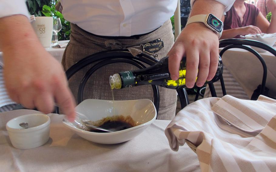 A server will mix up a vinaigrette tableside for diners' salads upon request at Ristorante San Lorenzo in Sirmione, Italy.  