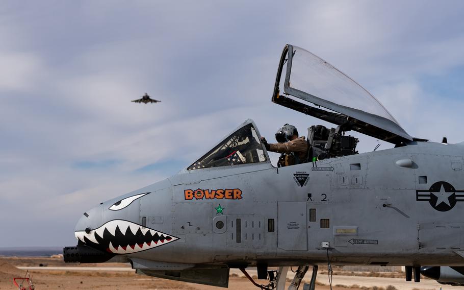 An A-10C Thunderbolt with a growling animal, seemingly a shark, painted onto its nose.