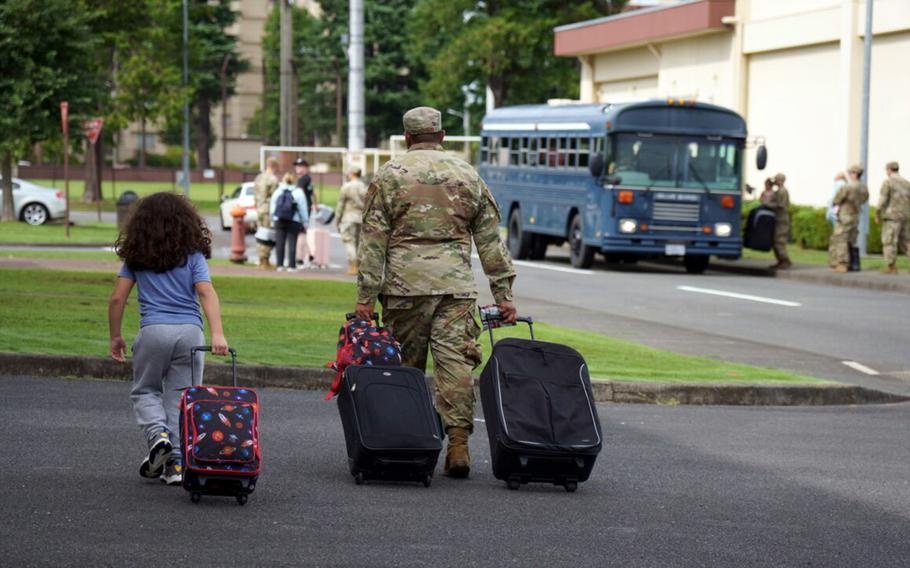 Service members and their family members take part in an evacuation exercise at Yokota Air Base, Japan, Thursday, Sept. 7, 2023.