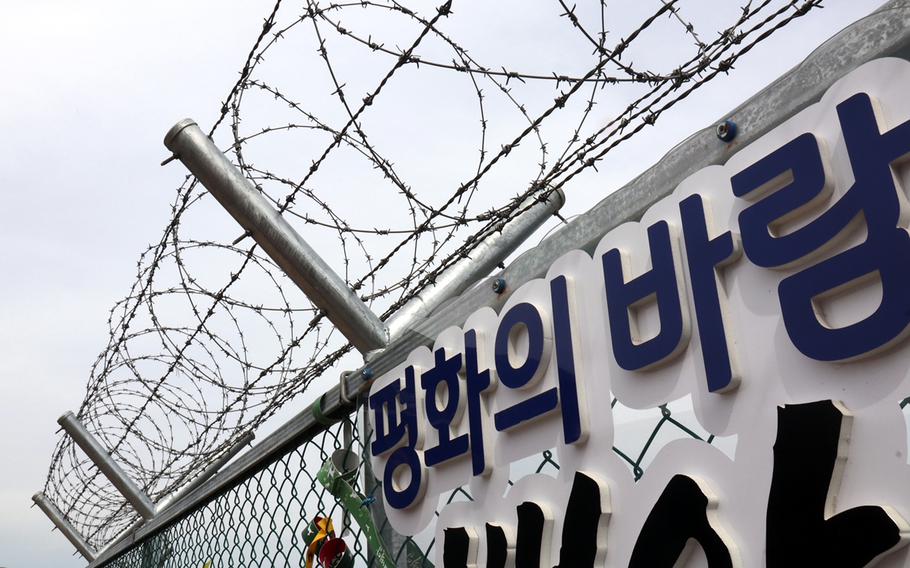 “Winds of Peace.” A sign on a barbed wire fence broadcasts a hopeful message on Baegamsan Mountain in Hwacheon County, South Korea, near the border with the North, May 2, 2023.