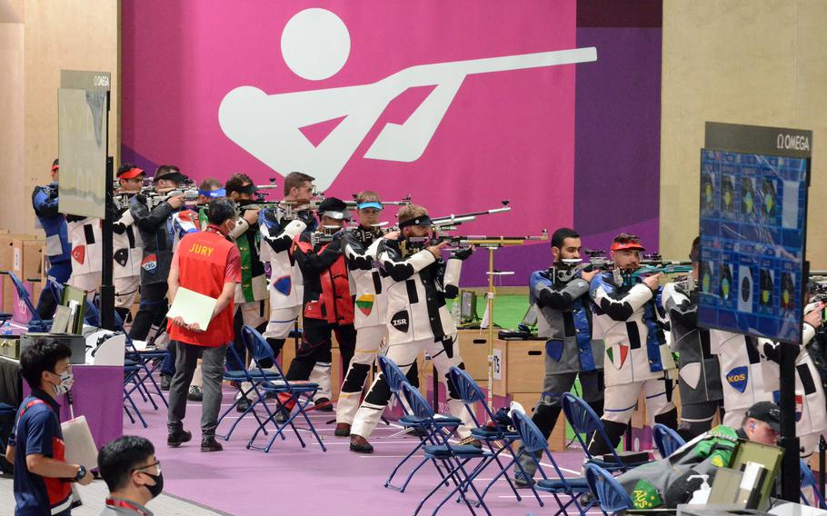 Athletes fire rifles at targets 10 meters away during an Olympic qualifying round at Camp Asaka, Japan, Saturday, July 24, 2021. 