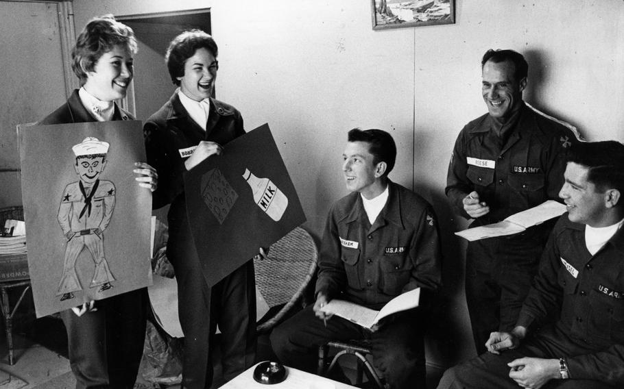Two women and three guys laugh together