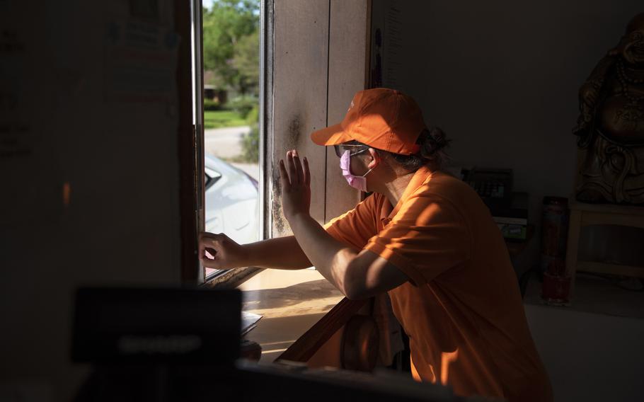 Angel Nguyen, 17, greets a customer at Bonny's Donuts in Dickinson, Texas on Aug. 14, 2021. 