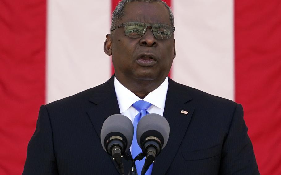 Defense Secretary Lloyd Austin introduces President Joe Biden during the National Memorial Day Observance at the Memorial Amphitheater in Arlington National Cemetery, Monday, May 31, 2021.