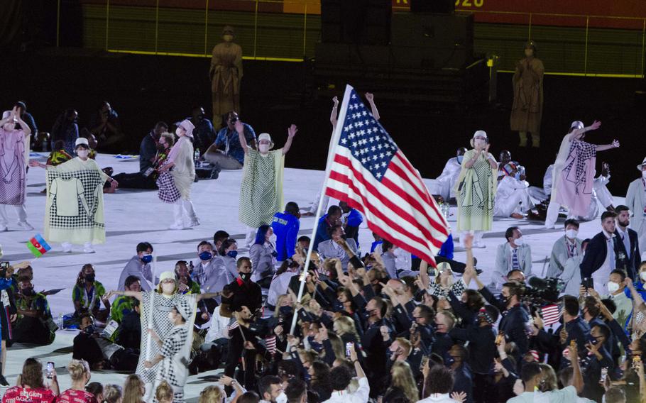 Member of Team USA march into Japan’s National Stadium during Friday’s Olympic opening ceremony. 